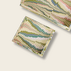 Two woven fabric boxes with a colorful pattern on a beige background
