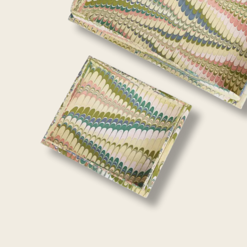 Two woven fabric boxes with a colorful pattern on a beige background