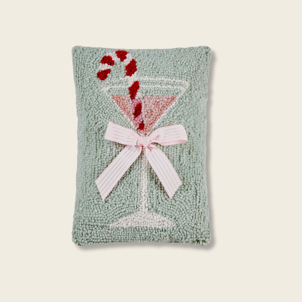 Decorative pillow with a martini glass design on a light background