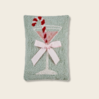 Decorative pillow with a martini glass design on a light background