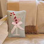 Decorative pillow with a cocktail design on a couch