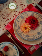Merlot and gold star cotton tablecloth draped over a table edge