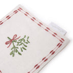 Mistletoe drink napkin placed under a glass