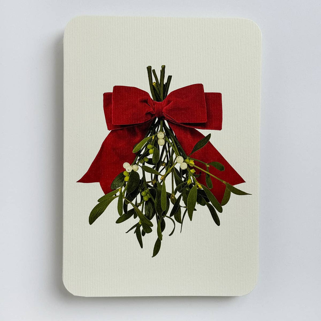Card with mistletoe and red bow on a light gray background