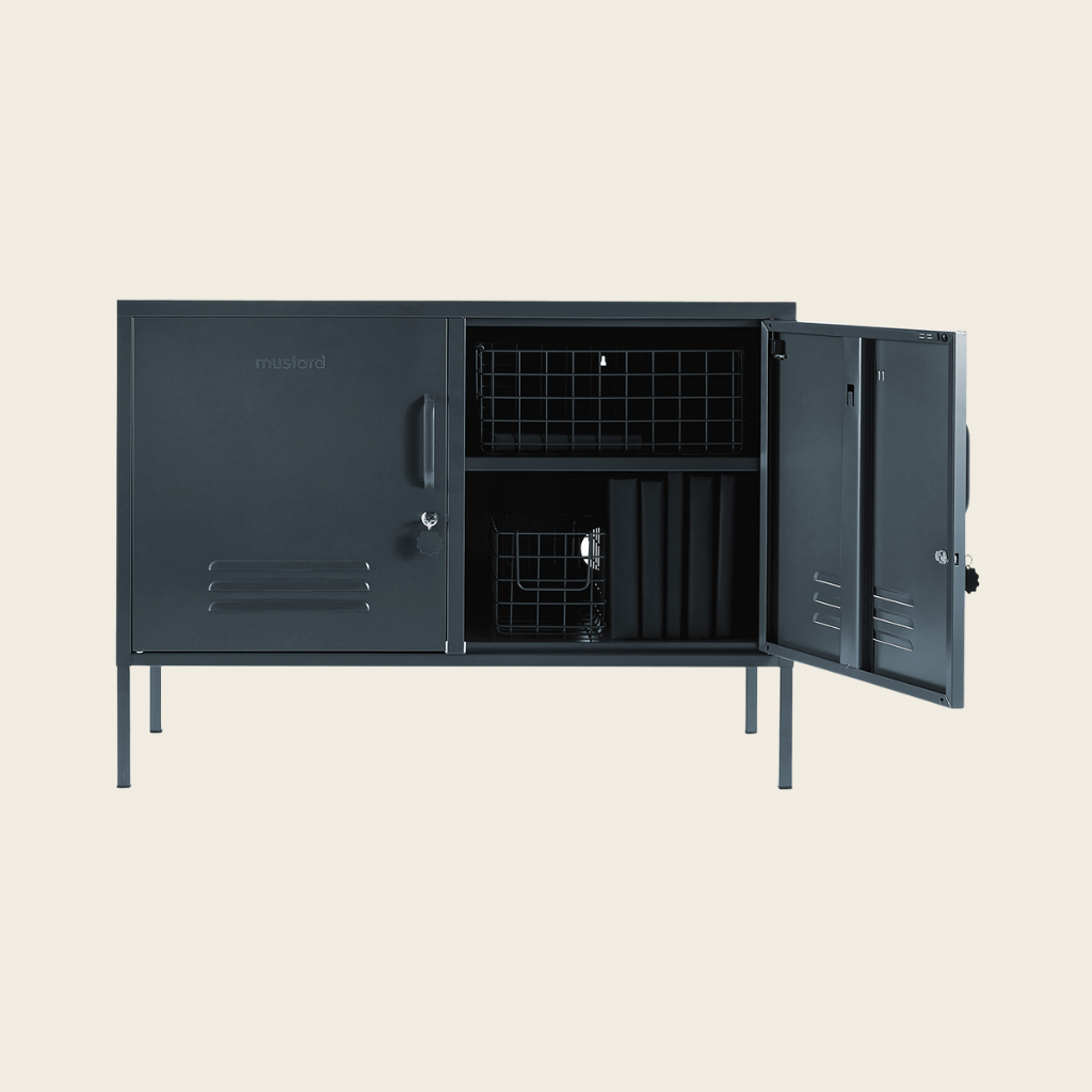 Black metal locker with open doors on a beige background