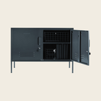 Black metal locker with open doors on a beige background