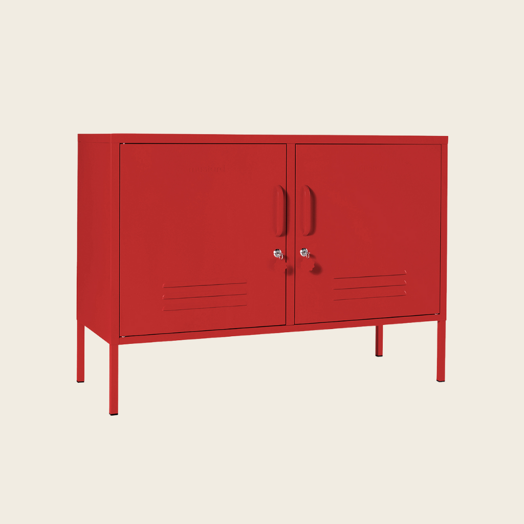 Red metal cabinet with two doors on a beige background