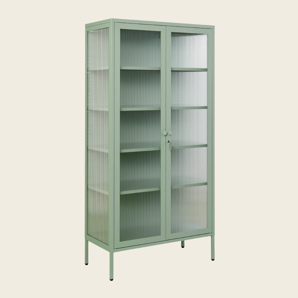 Green metal cabinet with glass doors on a beige background