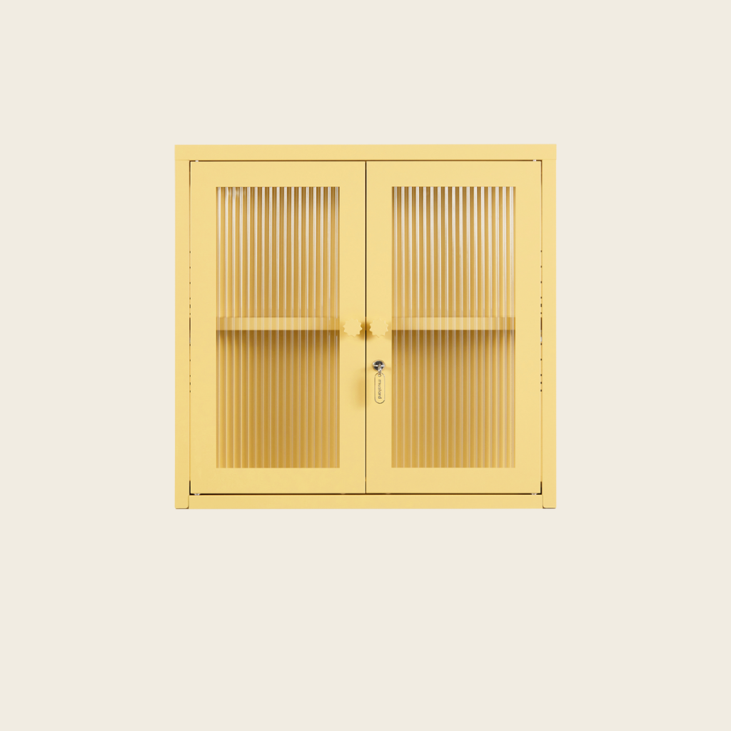 Yellow metal cabinet with double doors on a beige background