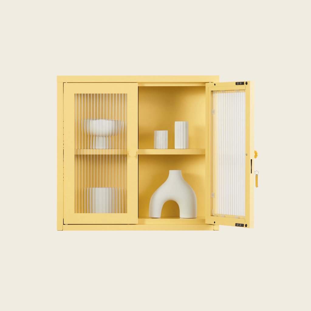 Yellow cabinet with glass doors displaying decorative items on a beige background