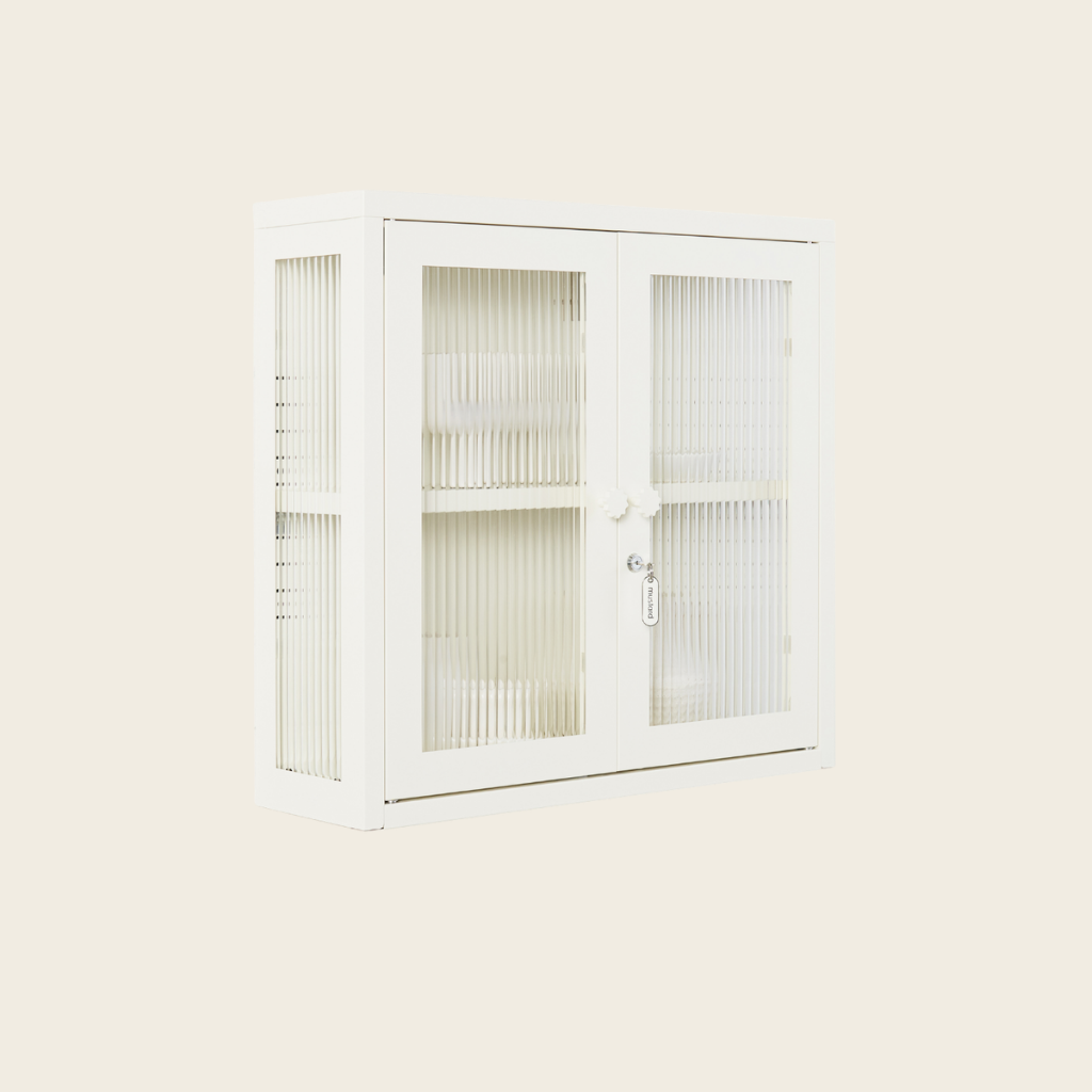 White cabinet with glass doors on a light beige background