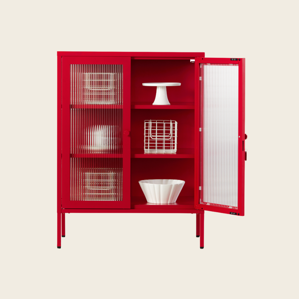 Red cabinet with open doors displaying white kitchenware on a beige background