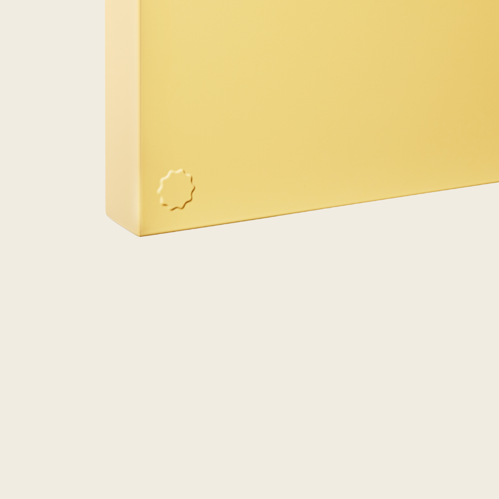 Yellow rectangular object with a logo on a light beige background