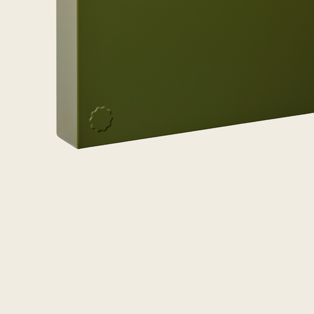 Green corner of a product on a beige background
