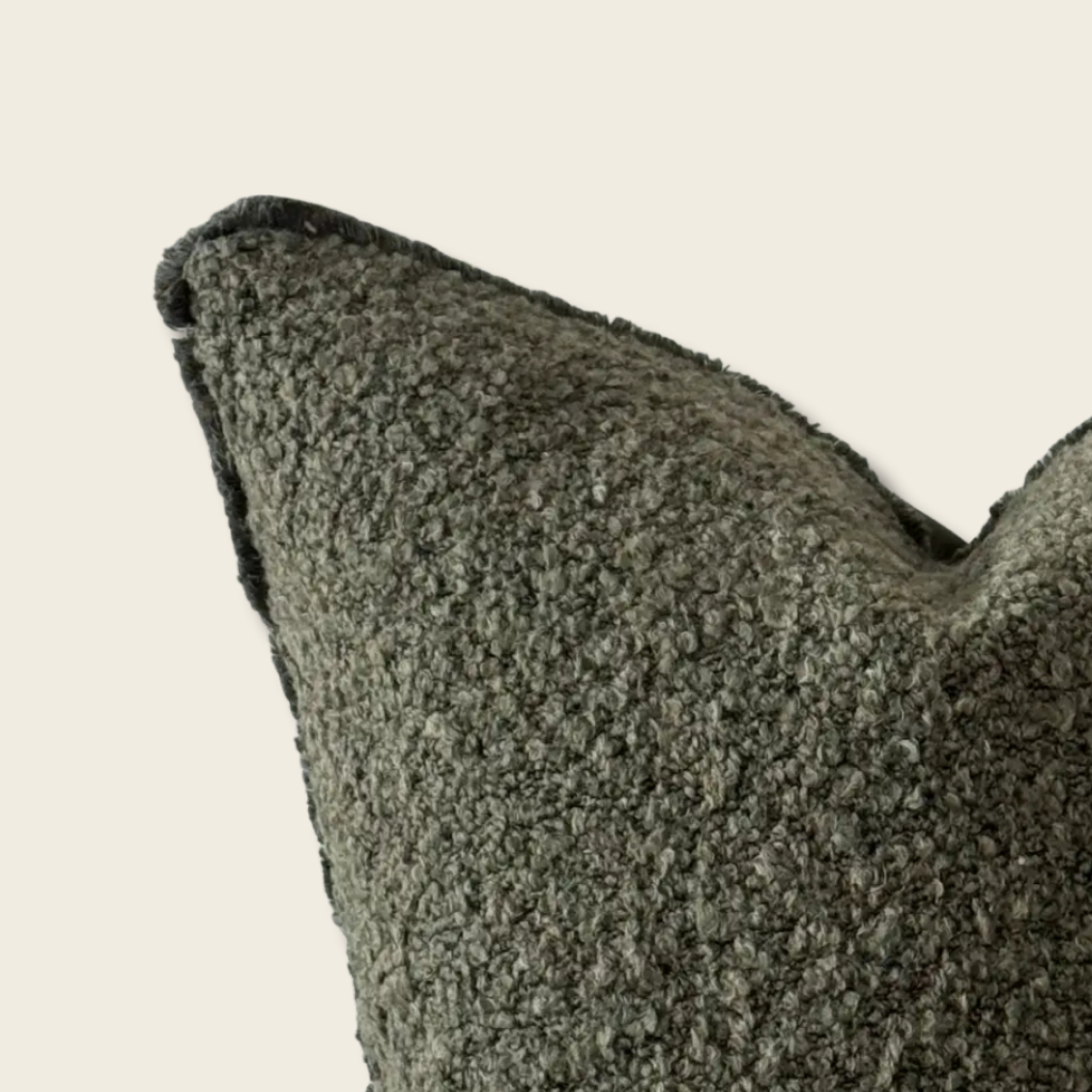 Boucle textured cushion detail on a beige background