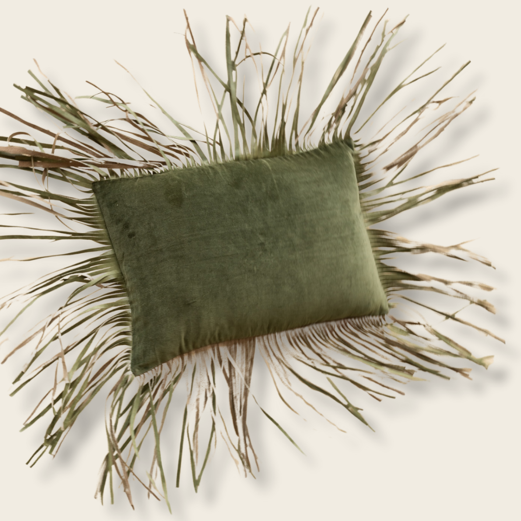 olive cushion with fringe being thrown