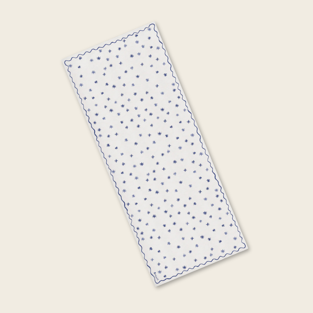 Rectangular white fabric with blue star pattern on a beige background