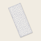Rectangular white fabric with blue star pattern on a beige background