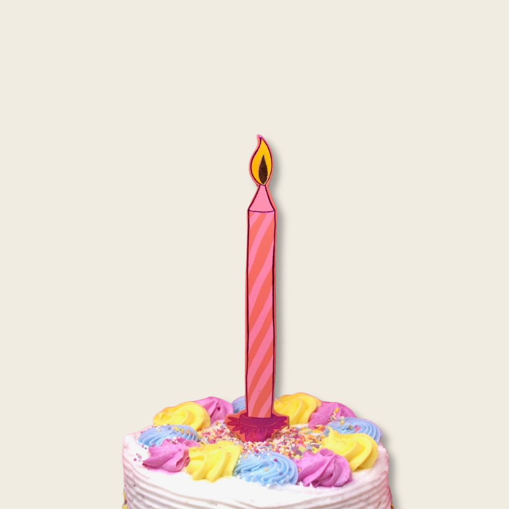 Colorful birthday cake with a single candle on a white background