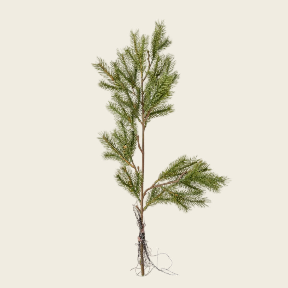 Artificial pine branch on a white background