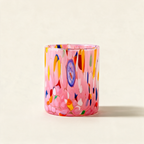 Pink Murano blown glass tumbler flecked with mixed colours on a cream background