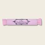 roll of pink wish paper on a beige back ground