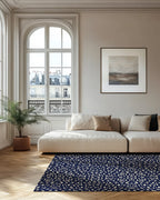 Pluma ink rug styled in a bright, pale living room