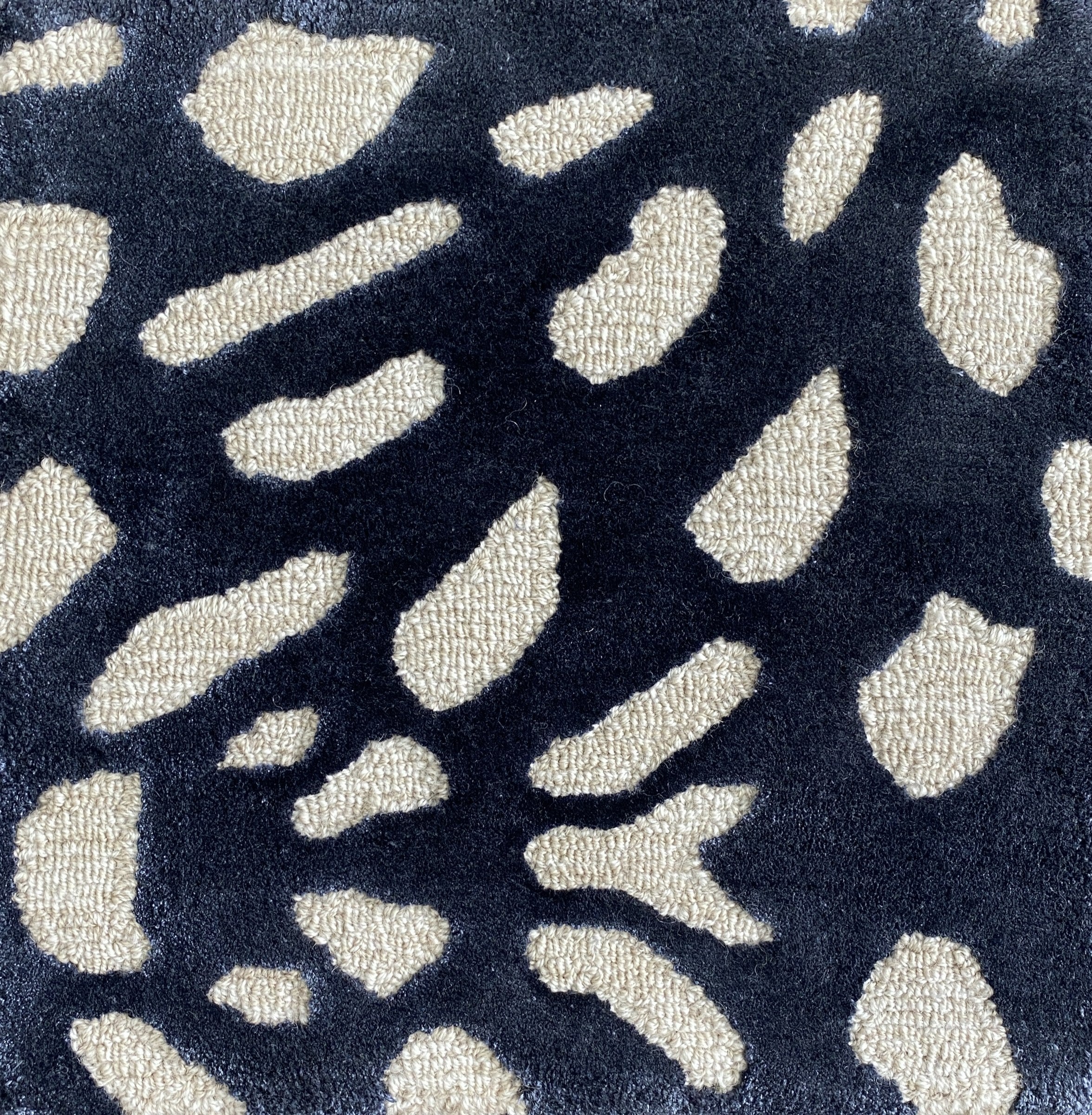 Detail of the Pluma ink rug pile, cream and gold flecks on navy