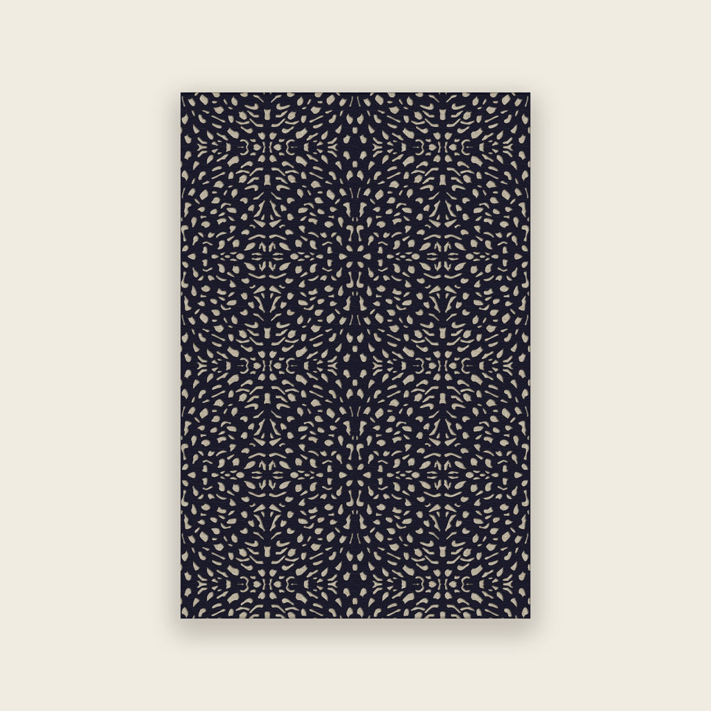 Pluma hand tufted rug in ink, small cream and gold motifs scattered over deep navy, shown flat