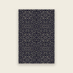Pluma hand tufted rug in ink, small cream and gold motifs scattered over deep navy, shown flat