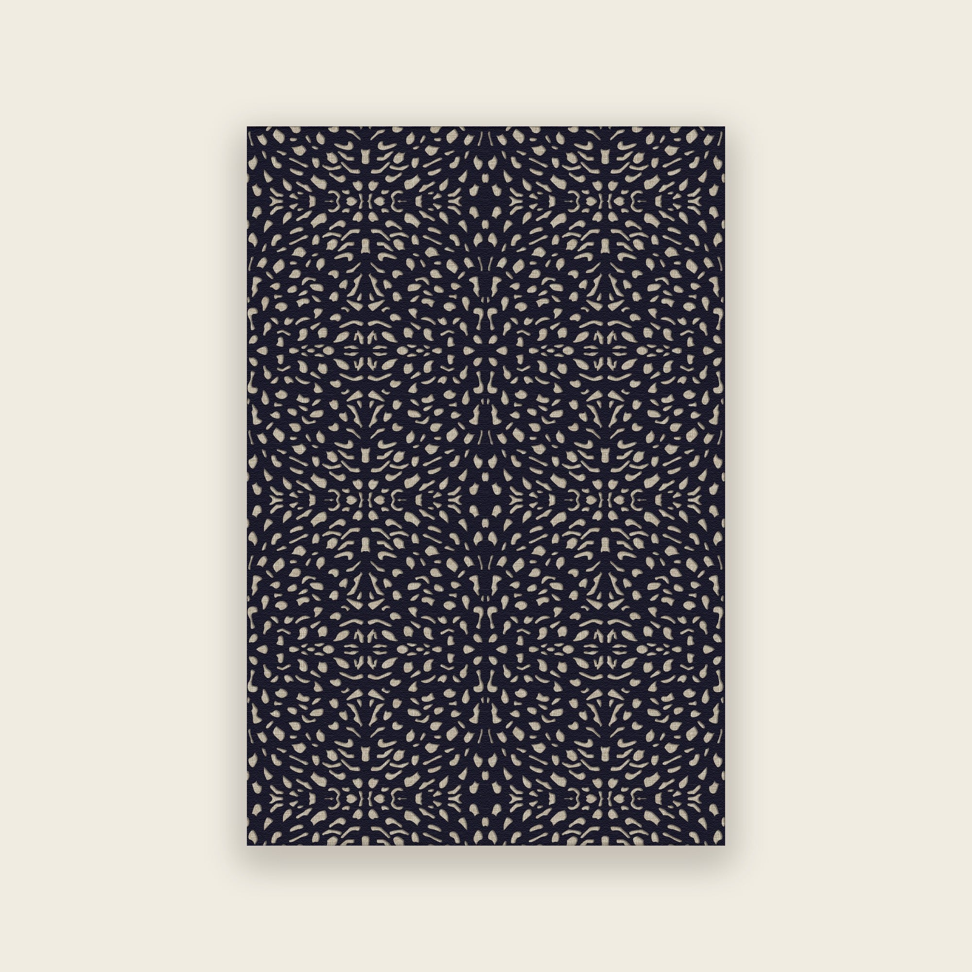 Pluma hand tufted rug in ink, small cream and gold motifs scattered over deep navy, shown flat