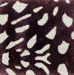 Detail of the Pluma mulberry rug pile, cream and gold flecks on aubergine