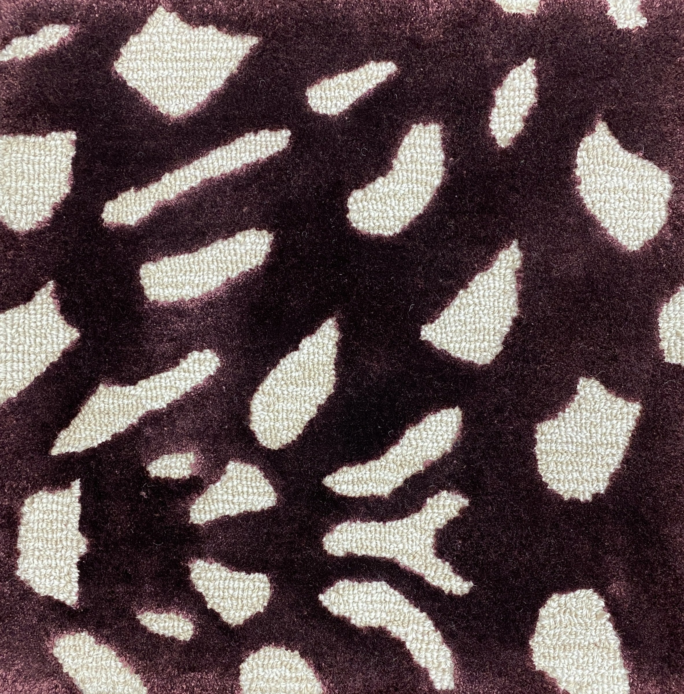 Detail of the Pluma mulberry rug pile, cream and gold flecks on aubergine