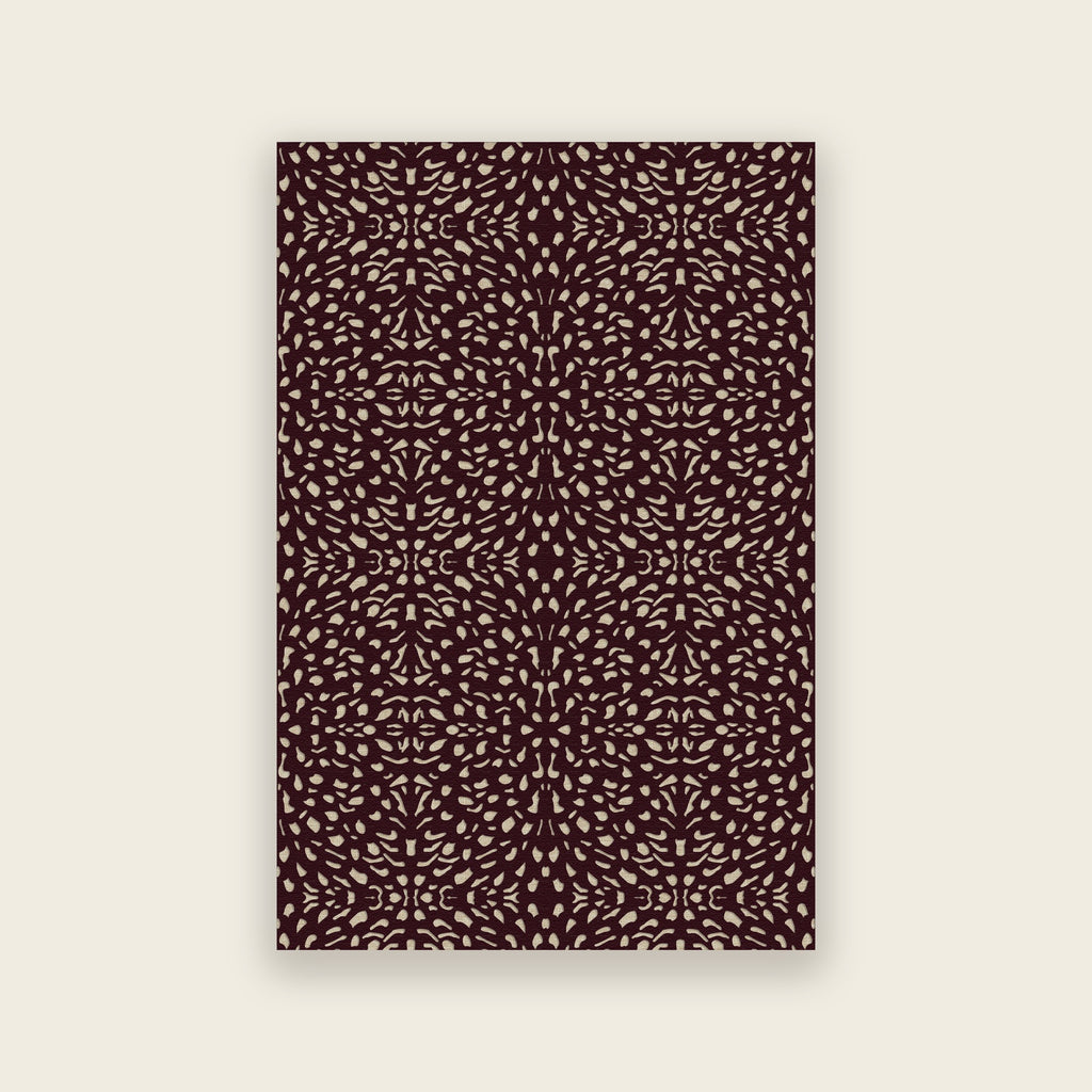 Pluma hand tufted rug in mulberry, cream and gold motifs scattered over deep aubergine, shown flat