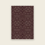 Pluma hand tufted rug in mulberry, cream and gold motifs scattered over deep aubergine, shown flat