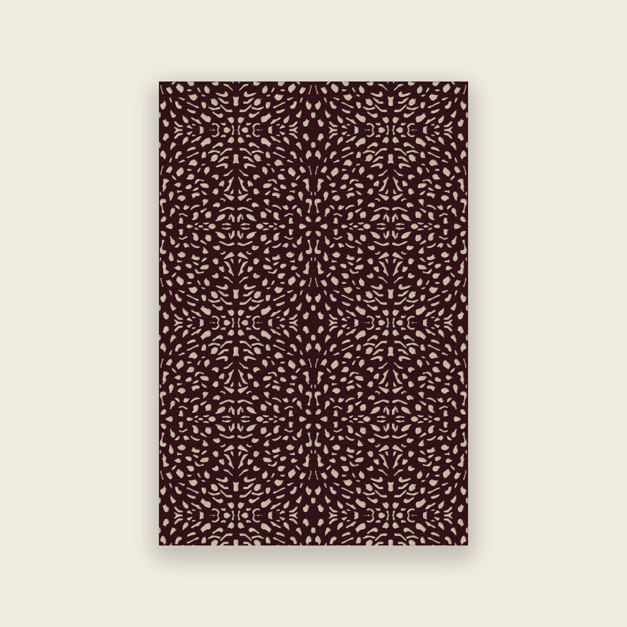 Pluma hand tufted rug in mulberry, cream and gold motifs scattered over deep aubergine, shown flat