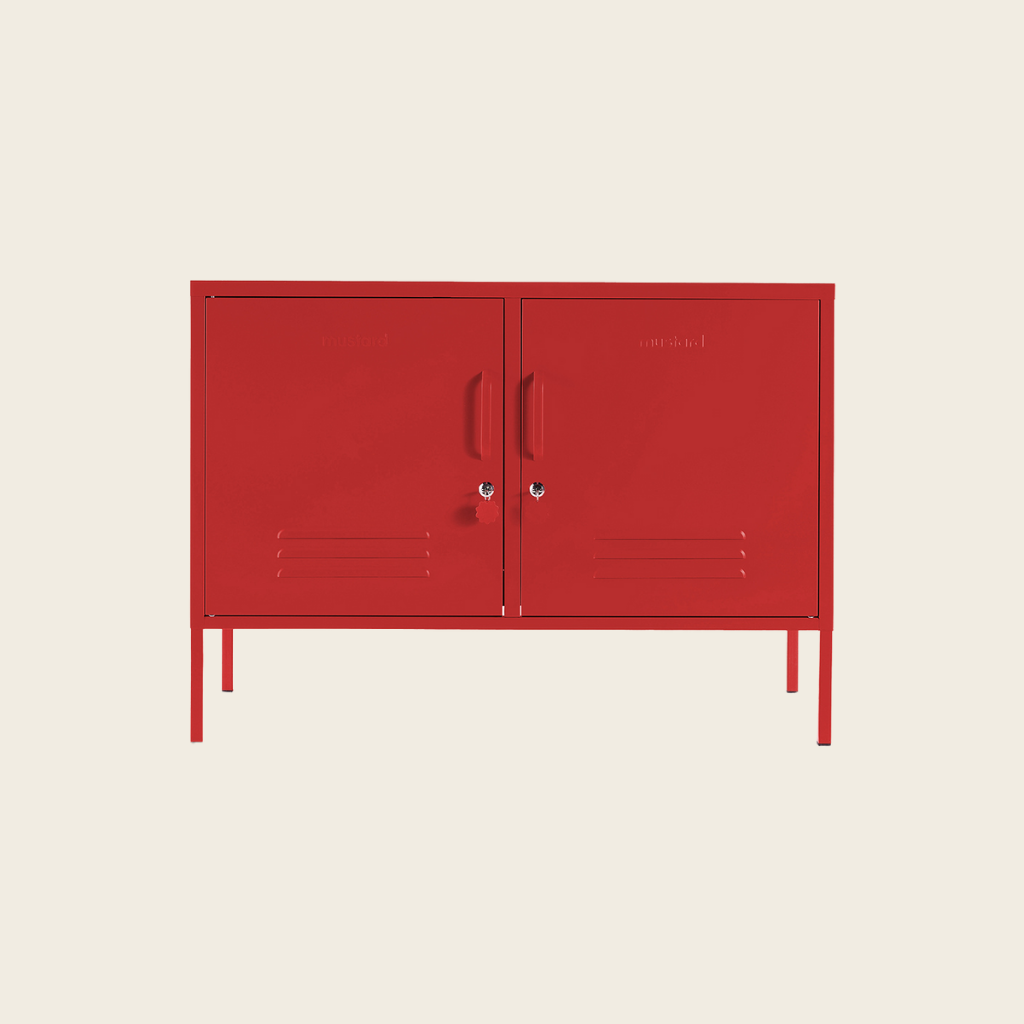Red metal cabinet with two doors on a beige background