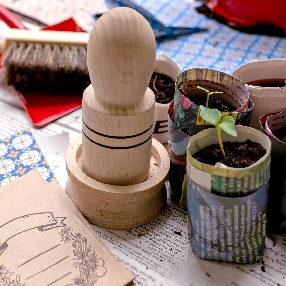Wooden stamp set on a table with gardening tools and plants