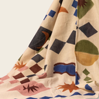 Colorful geometric patterned fabric with shapes on a beige background