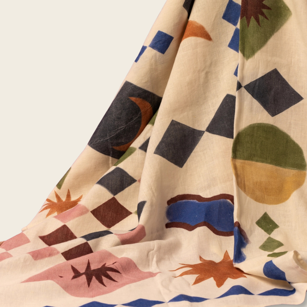 Colorful geometric patterned fabric with shapes on a beige background