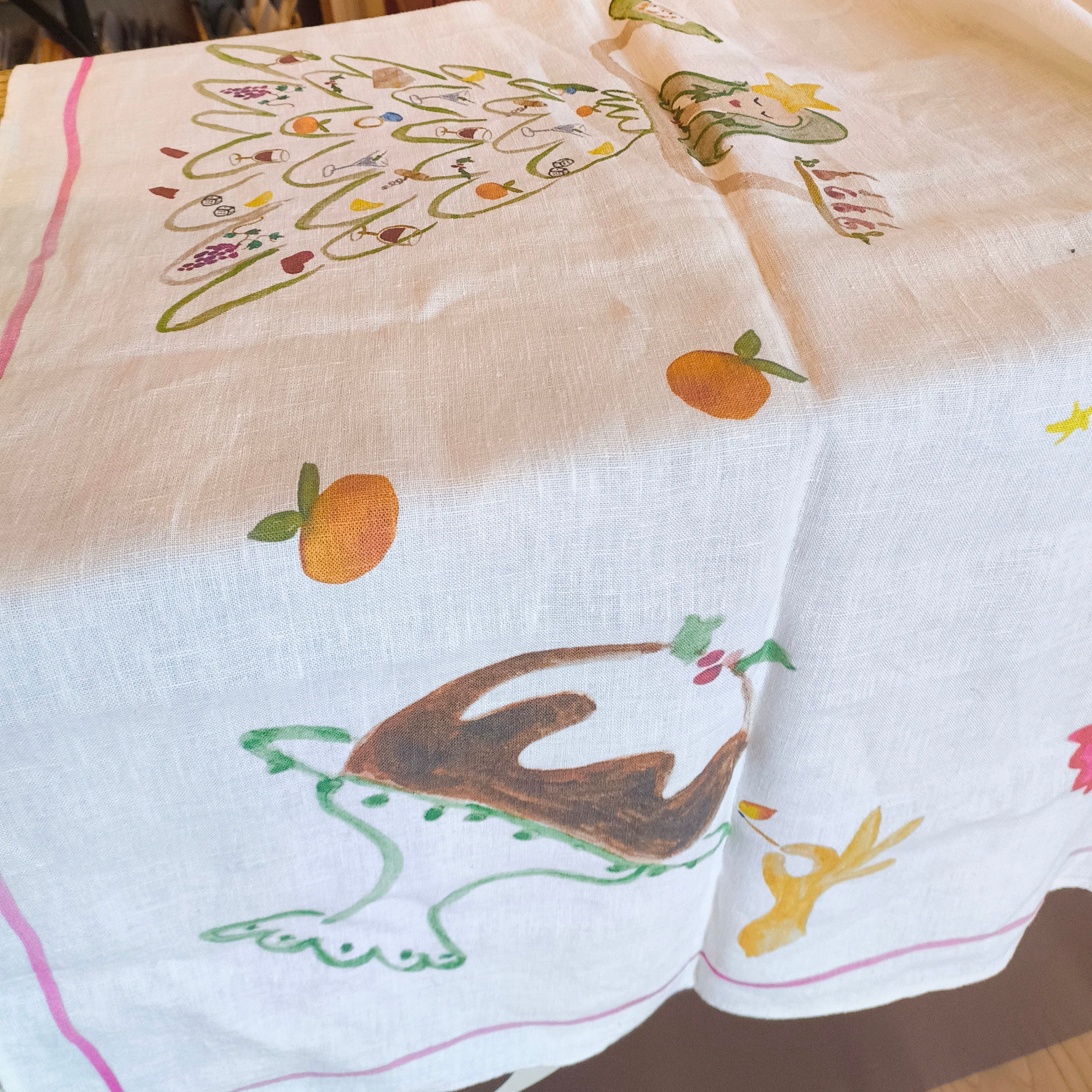 Embroidered tablecloth with decorative patterns on a wooden surface