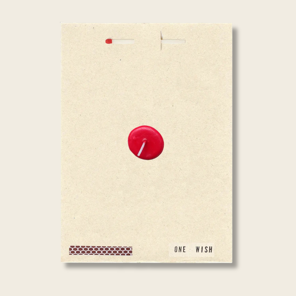 Beige card with a red candle illustration and 'One Wish' text on a light gray background