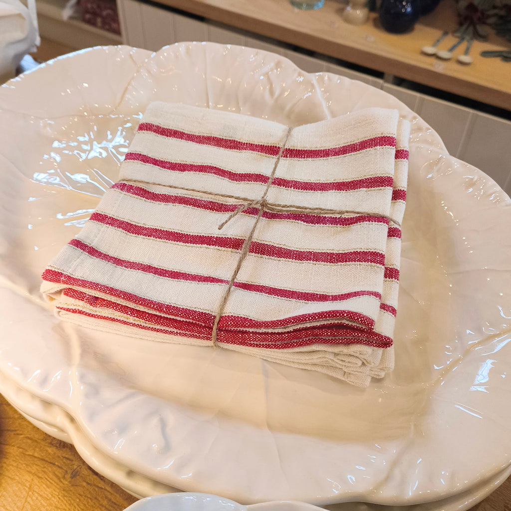 White ceramic plate with a red and white striped cloth on a wooden surface