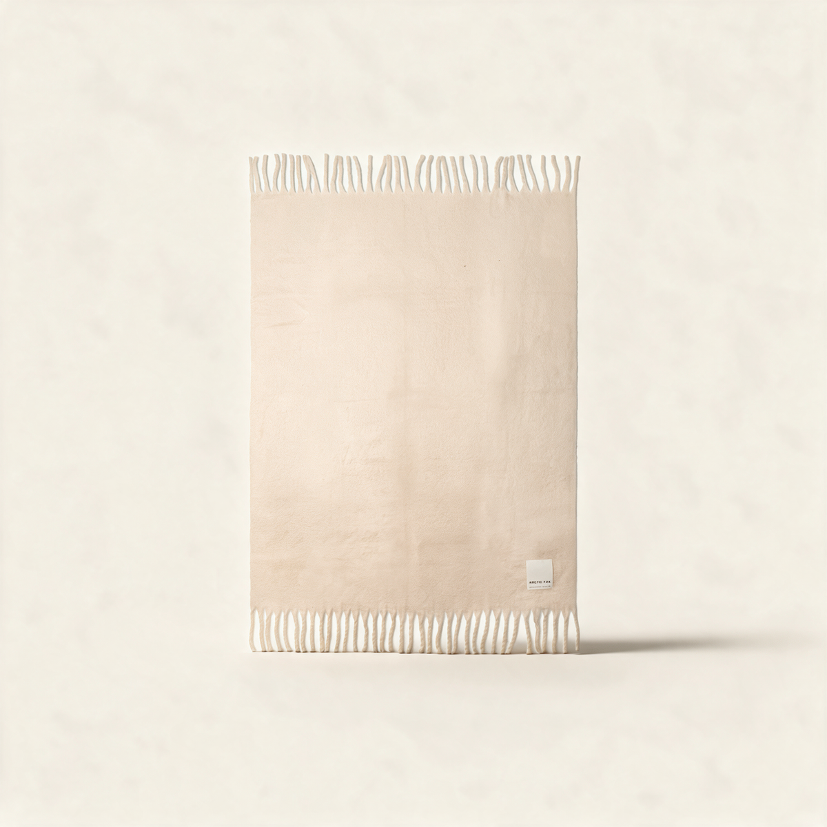 The Reykjavik Throw in pebble beige, a recycled brushed fleece blanket