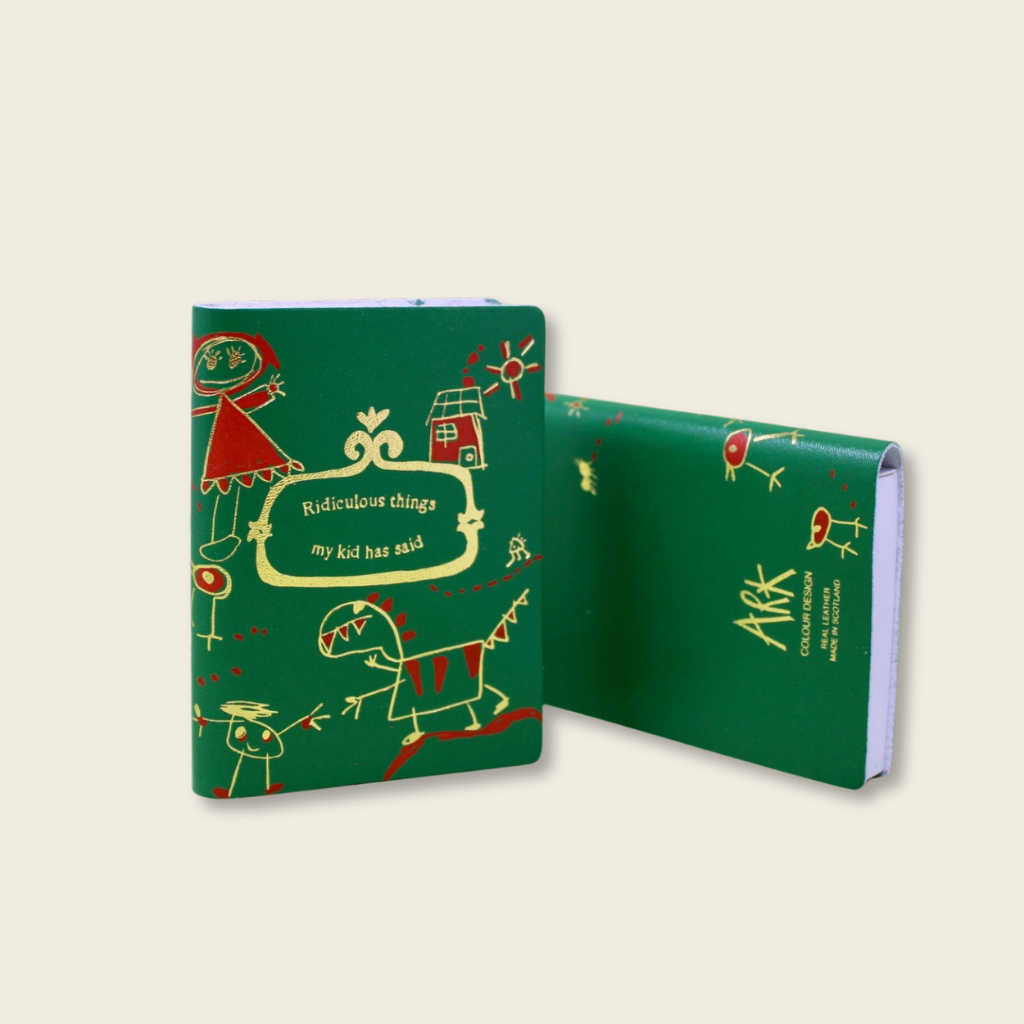 Green notebook with colorful illustrations on a beige background