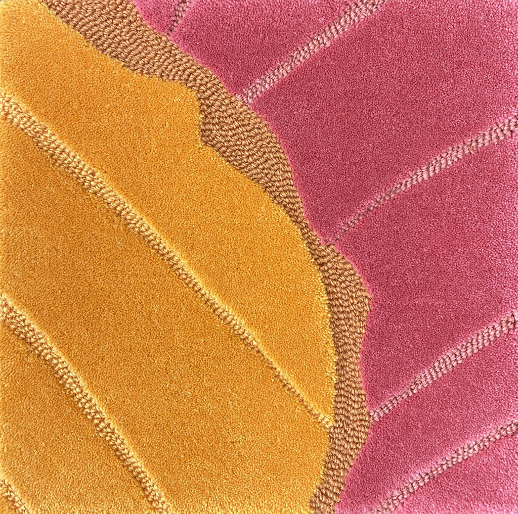Detail of the Ripple horizon rug pile in amber and rose pink