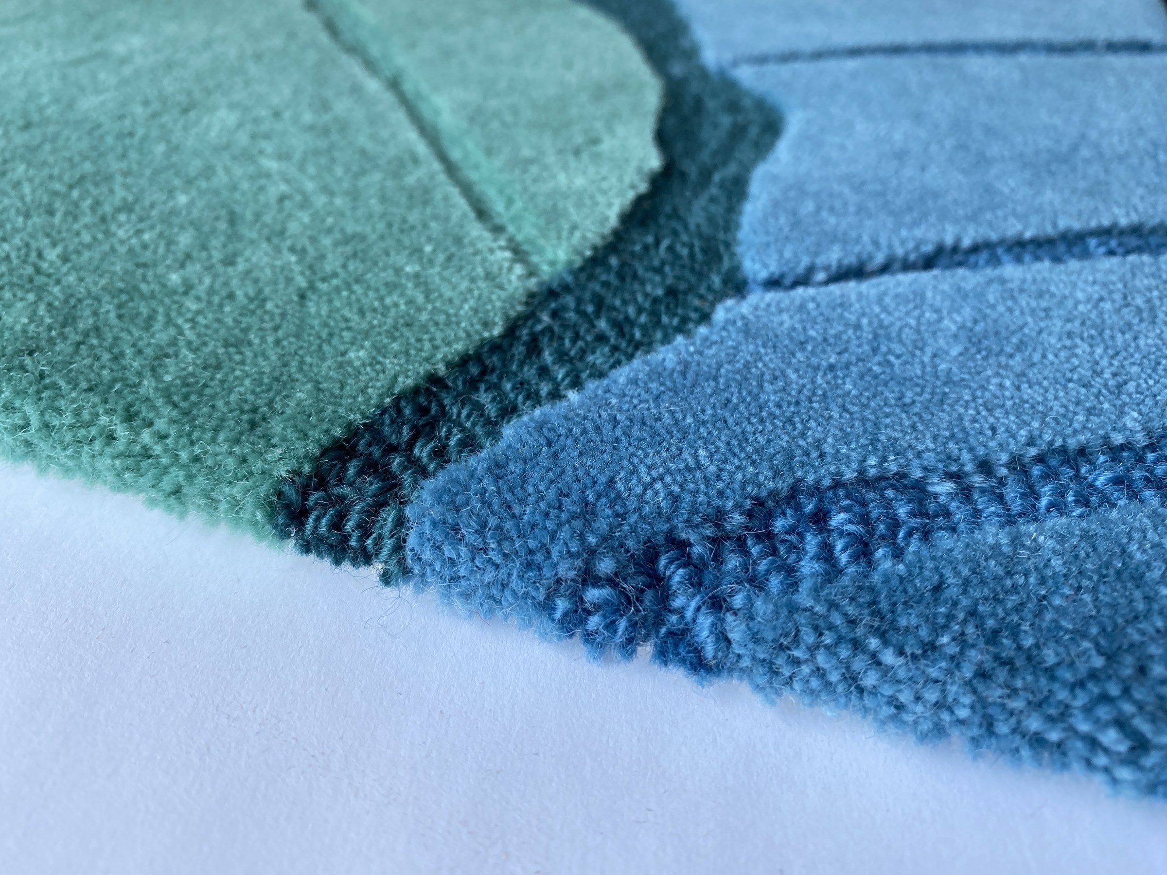 Close up of the Ripple tide rug showing the cut and loop pile and fine wave lines