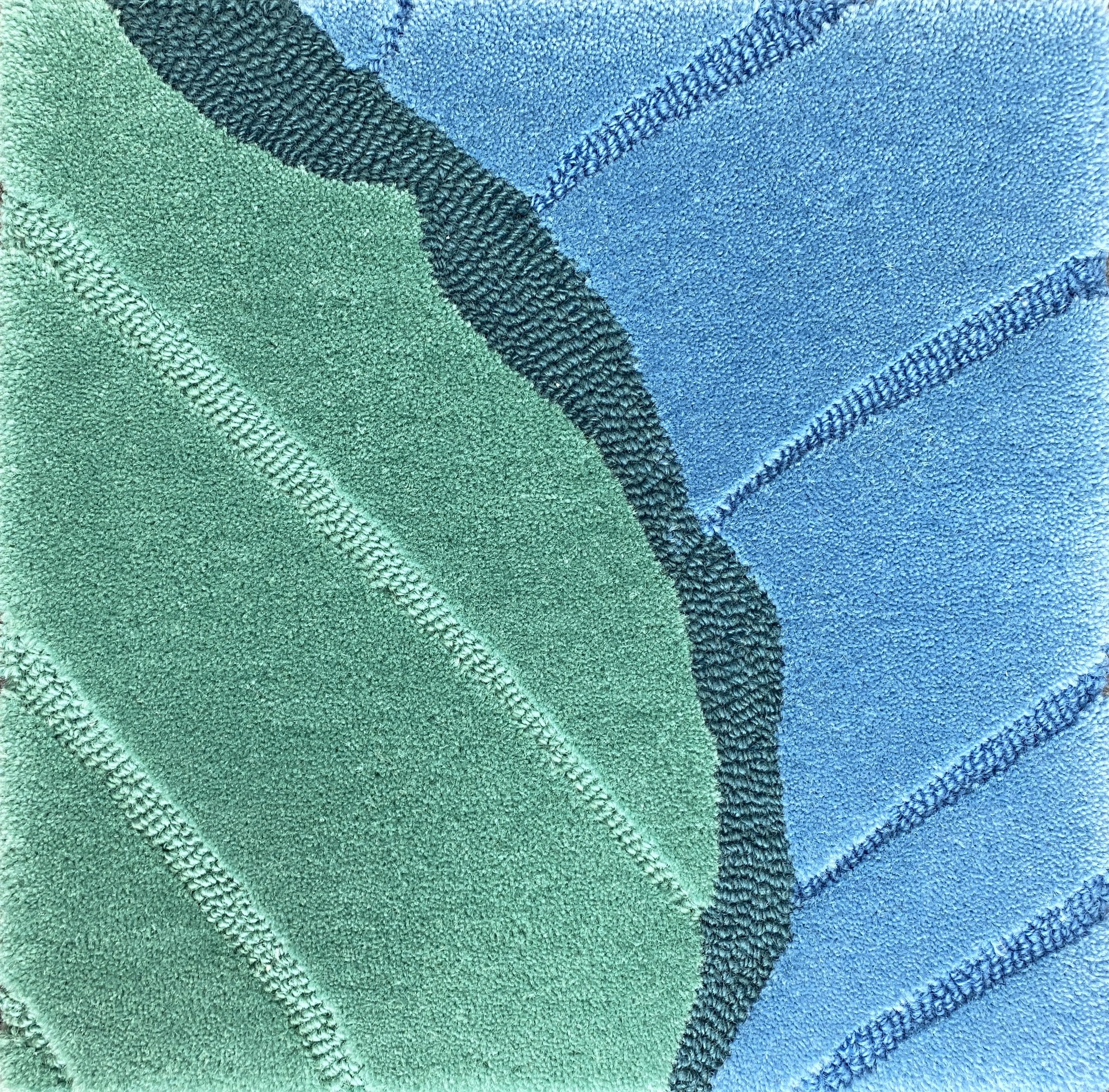 Detail of the Ripple tide rug pile in sea green and ocean blue