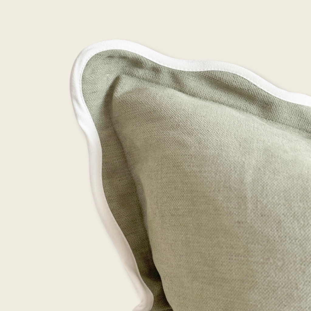 corner of green cushion on beige background