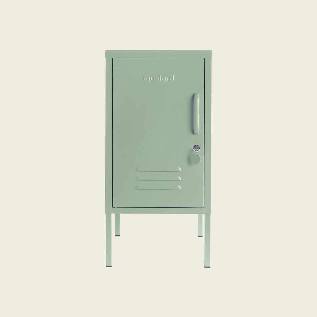 Sage metal locker on a beige background